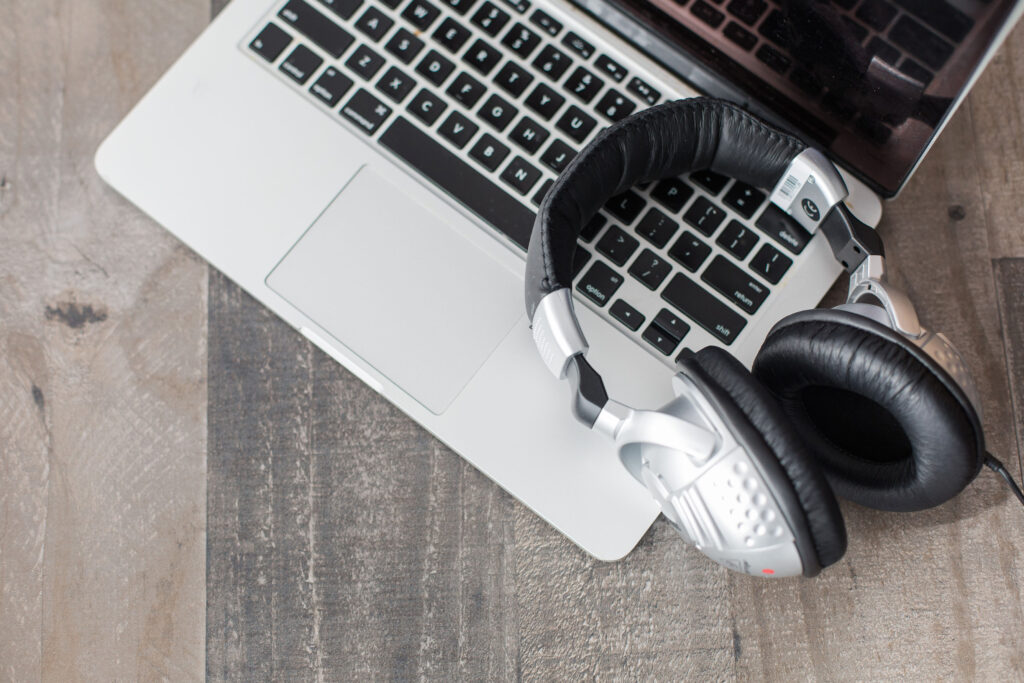 Headphones and laptop for podcasting